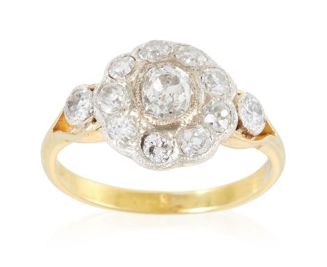 A DIAMOND CLUSTER RING in high carat yellow gold set with a cluster of old cut diamonds totalling 1.35 carats, unmarked, size