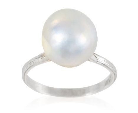 A PEARL DRESS RING in platinum, set with a single pearl of 10.1mm to a plain band, stamped Plat, size K / 5, 3.0g.