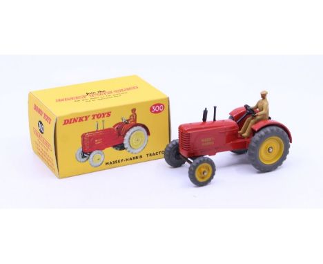 Dinky: A boxed Dinky Toys, Massey-Ferguson Tractor, Reference No. 300, red body, yellow wheel hubs, black chimney stacks, dri