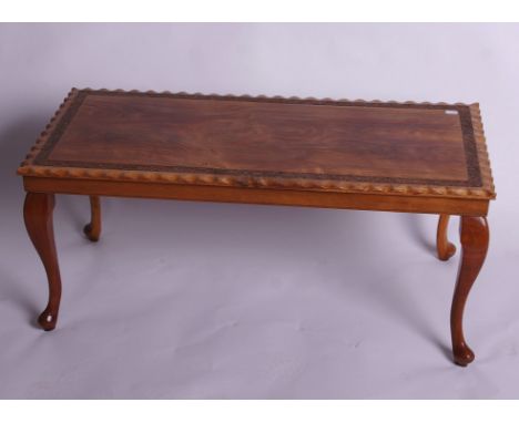 An Indian teak coffee table with carved boarder (top 92x44cm) and and Indian carved standard lamp -sold as parts