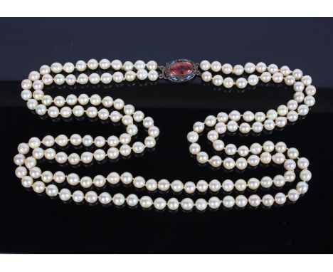 An Early/Mid 20th Century two strand of cultured pearls with a silver and enamel clasp