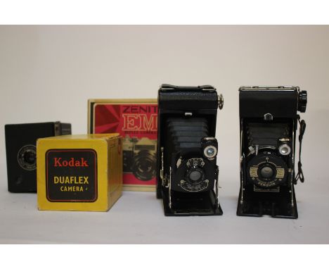 A boxed Zenit EM reflex, a Kodak N01 pocket folding camera with original box, a Penguin Kershaw 8-20 folding camera with inst