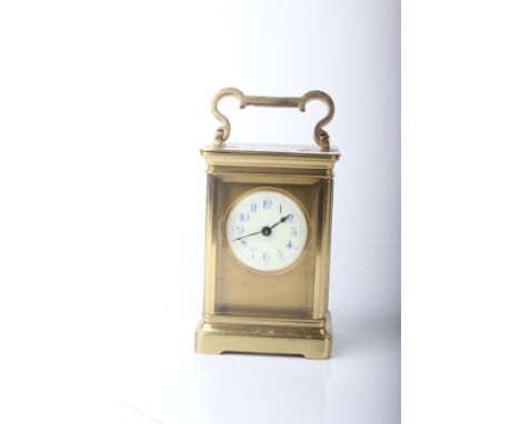 A carriage timepiece, enamel dial in a brass case, handle raised 16cm high