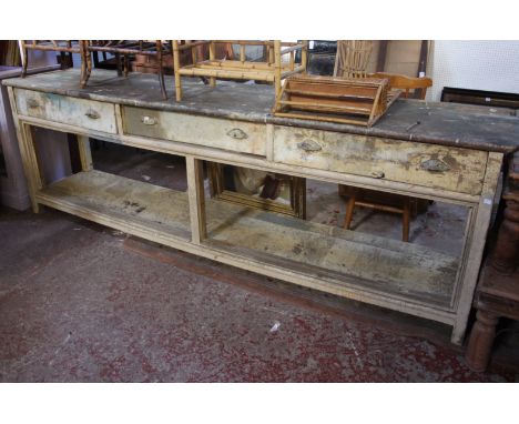 A large Victorian painted pine dresser base fitted three drawer over a full width low shelf originally with sliding doors, po