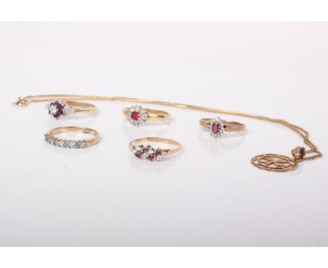 A collection of jewellery comprising; A 9ct gold, ruby and diamond oval cluster ring, a ruby and diamond press ring, a half e