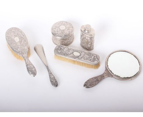A late 19th century Chinese export part dressing table set by Hung Chong, each embossed with birds amidst foliage on a matt g