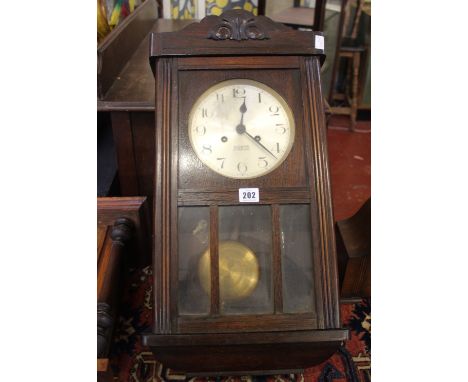 A 1930's wall clock, 8 days striking movement and a Smith two train arch top mantle clock