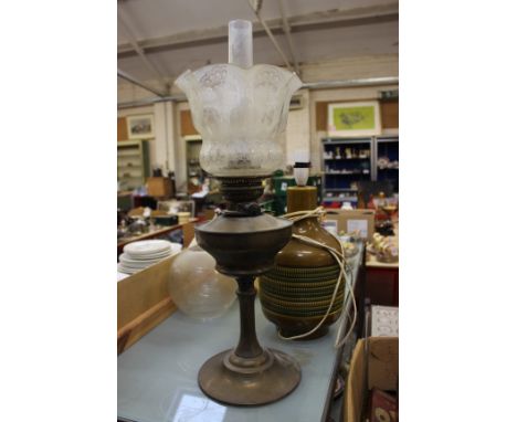 A Victorian brass paraffin lamp with an etched shade, five glass shades and a pottery table lamp