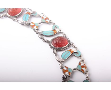 An Egyptianesque white metal, enamel and carnelian bracelet, with form or four oval carnelian scarab-carved cabochons with sc