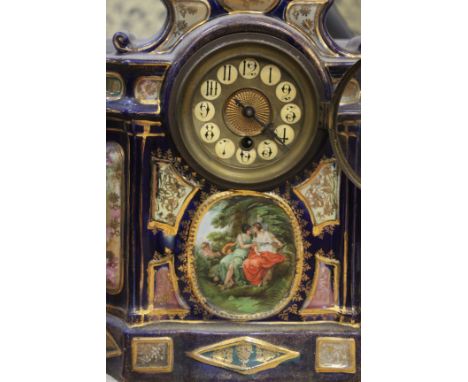 A Victorian clock garniture with a pottery ornamental clock case and a pair of matching vases decorated with amorous couplesC