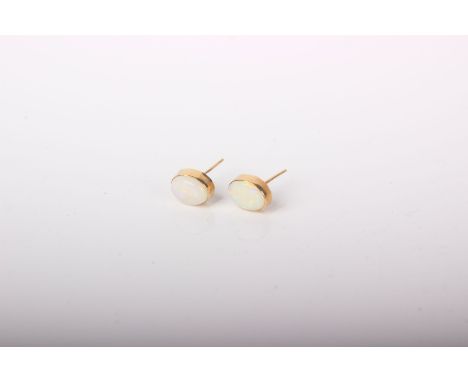 A pair of 9ct gold oval Cabochon white opal stud earrings, 1.1g in total