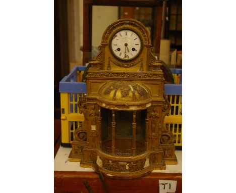An ornamental gilt gesso 'temple' cased mantel clock for restoration, a small glass dome, various clock bases/stands and a ma