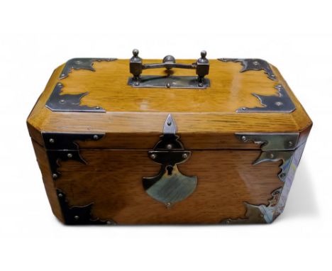 A Victorian canted oak tea caddy, with bold plated handle, escutcheon and brackets to angles, 12cm high, 22cm wide, c.1870
