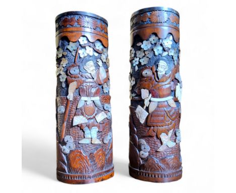 A large pair of Japanese Meiji period carved bone and mother of pearl inlaid bamboo brush pots, depicting Samurai under a blo