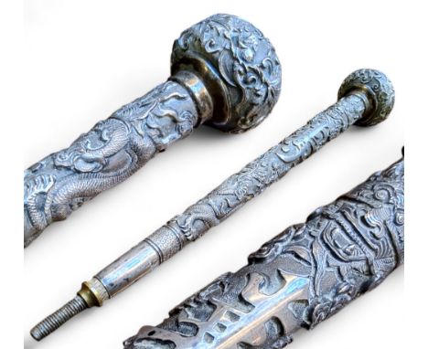 Chinese Export - a Qing Dynasty parasol handle, well cast in relief with ferocious dragons chasing the flaming pearl amongst 
