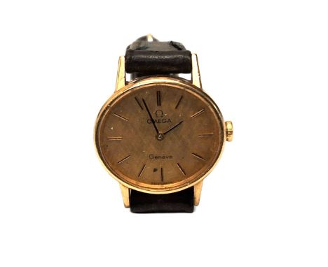 A 9ct gold Omega Geneve lady's wrist watch, manual movement, gold coloured textured dial, gold baton markers, w/o, later blac