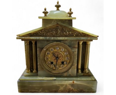 An early 20th century French onyx architectural mantel clock, Arabic numerals in circular apertures, domed top with gilt fini