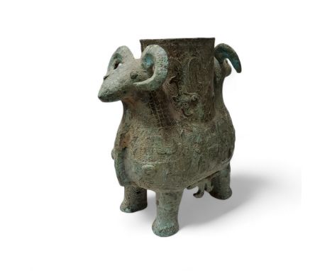 A Chinese archaic bronze double ram tsun offetory vessel,&nbsp; possibly 'Zun, Shang Dynasty' flanked by the heads and forequ