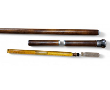 A  19th century walking stick, white metal finial, the shaft in two sections with long clear glass liqueur bottle and glass, 