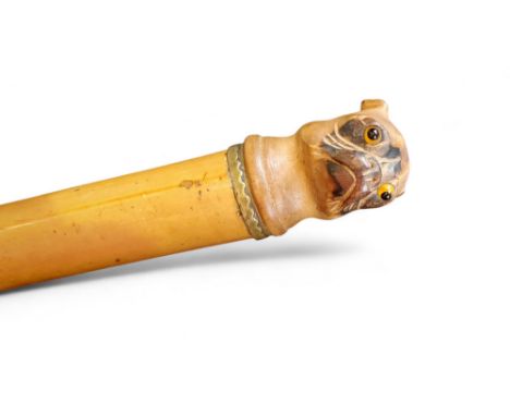 A 19th century novelty walking stick, the pommel carved as the head of a pug, glass eyes, malacca cane, 86cm long