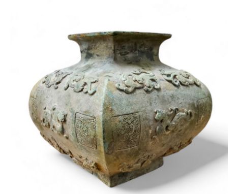 A Northern China archaic bronze temple vessel, decorated in relief with 'feline' and dragon motifs and intermitted square sta