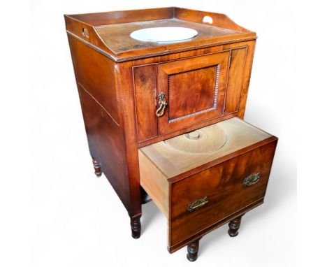 A George IV mahogany tray top commode, pierced handles above cupboard door and a drawer-commode, turned legs, 87cm high, 58cm