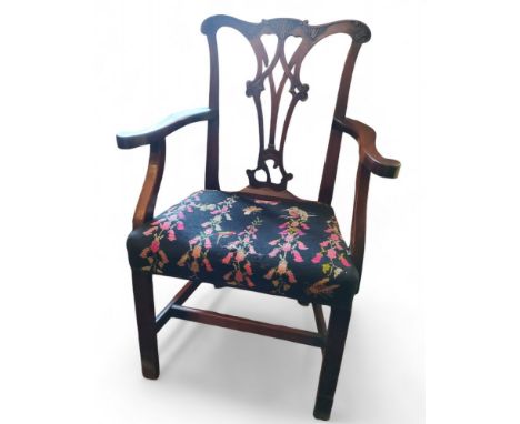 A George III Chippendale elbow chair, pierced vasular splat, scroll arms, tapestry seat, H stretcher, c.1830