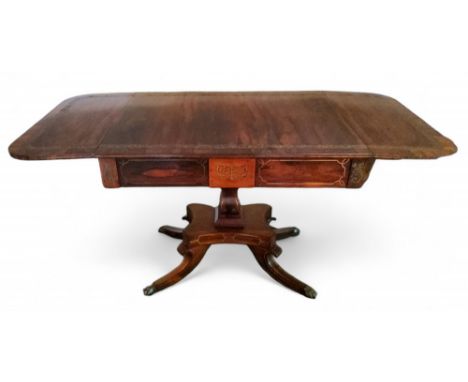 A Regency rosewood sofa table, rounded rectangular top with fall leaves with brass foliate band above a&nbsp; frieze drawer,&