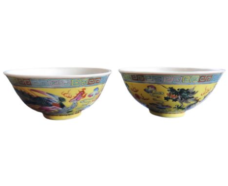 A pair of Chinese&nbsp; yellow ground bowls, decorated in polychrome with dragons chasing the flaming pearl, 11.5cm diam,20th