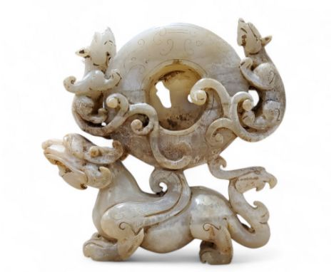 A Chinese Han Dynasty type Hetian white jade cabinet carving of a mythical Pixiu beast with a Ho-Ho bird tail holding a carve