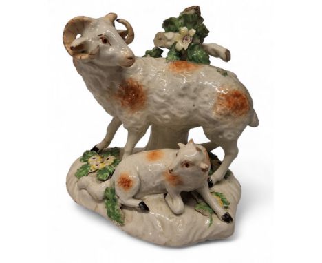 A Derby Patch Mark model, a ram and ewe, before bocage,&nbsp; shaped base encrusted with foliage, 13.5cm high, c.1770