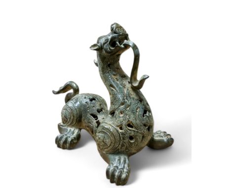 A Chinese Warring States archaic bronze Pixiu beast, possibly Late Eastern Zhou Dynasty, standing head aloft, profusely pierc