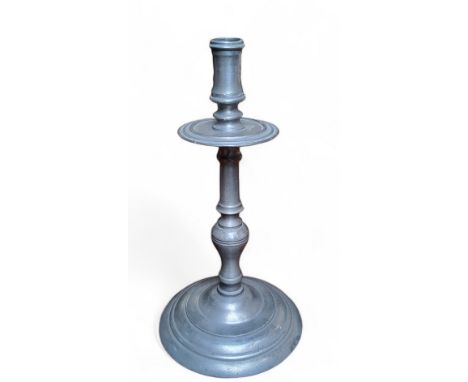 A late 18th century Continental pewter candlestick,  20cm high x 14cm diameter