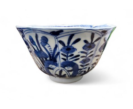 A Chinese flared cylindrical tea bowl, in underglaze blue with stylised foliage, in panels, the interior with sprigs, 8.5cm d