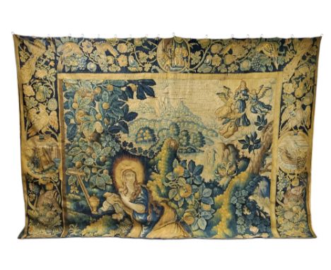 A late 17th/early 18th century Aubusson tapestry fragment depicting Mary Magdalene knelt in a landscape surrounded by fruitin