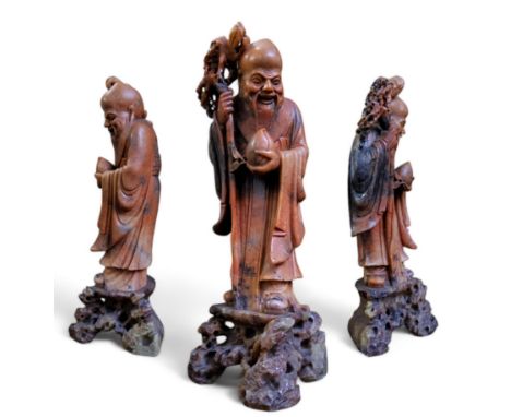 A Chinese Republic period (1912–1949) soapstone figure of the Shou Lao, God of Longevity, he stands with his pronounced bald 
