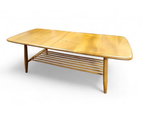An Ercol Windsor elm and beech coffee table, model 459, seven spindle gallery magazine rack, 36cm high, 45cm wide, 102cm long