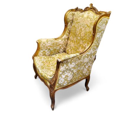 A French Louis XV Revival painted softwood fauteuil à oreilles, the shaped cresting carved with flowers and stiff leaves, the