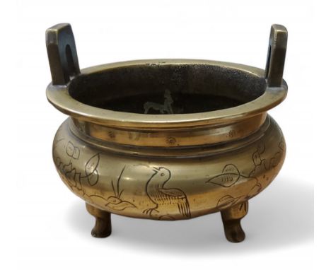 A Chinese bronze open censer, engraved with stylised birds and foliage, three stile feet,&nbsp;13cm wide