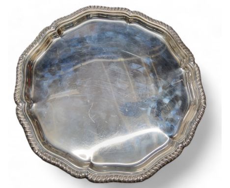 A silver shaped circular tray, gadrooned rim, bun feet, 30.5cm diam, William Hutton &amp; Sons Ltd, Sheffield 1918, 924g, 29.