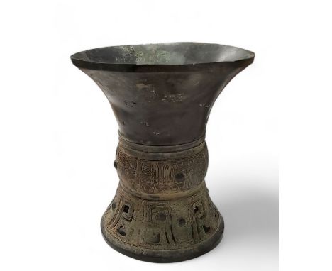 A Chinese archaic bronze ritual wine vessel, possibly Eastern Zhou Dynasty, the tapering body and spreading foot centred with