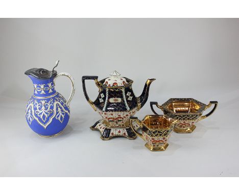 A Victorian gilt lustre tea service to include a teapot, stand, cream jug and sugar bowl, and a Cobridge blue stoneware jug w