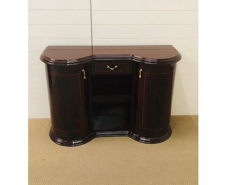 A high gloss rosewood console cabinet with drawer and bow fronted cupboard