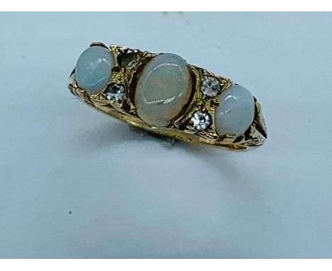 A Three Stone Opal ring on a 9ct yellow gold mount.