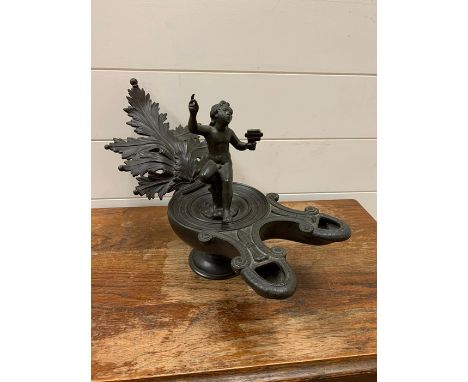 A Roman style oil lamp with figure of a boy