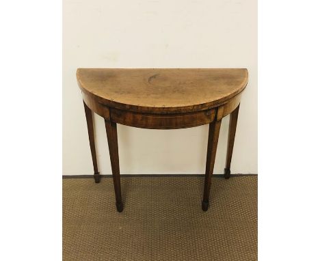 A yew demi-lune card table with string inlay detailing, a green felt top on tapered legs (W91cm D90cm H72cm)