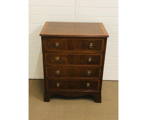 A small mahogany chest of drawers to include four drawers with brass pull ring handles 