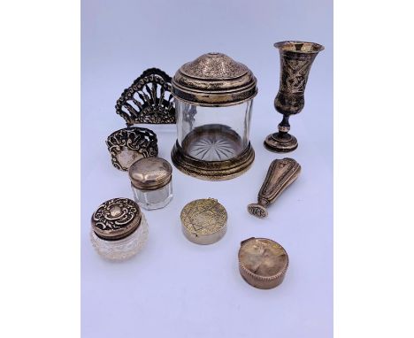 A Selection of silver items to include pill boxes, napkin ring, pots and a stamp.