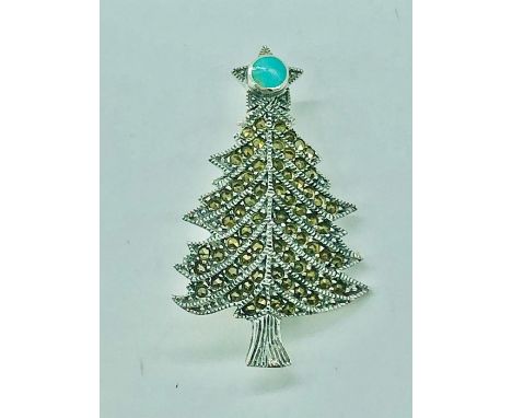 A silver  and marcasite Christmas Tree brooch set with an opal star finial.