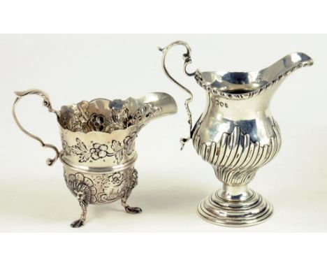 A VICTORIAN SILVER WRYTHEN FLUTED OGEE CREAM JUG WITH GADROONED RIM, LONDON 1891 AND ANOTHER OF HELMET SHAPE, DUBLIN 1912, 7O